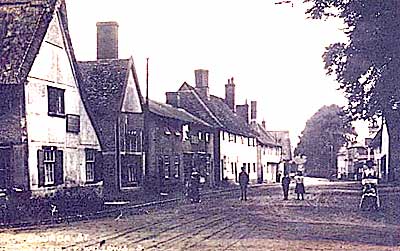 Black and white photograph of The Street looking east from the churchyard c.1900